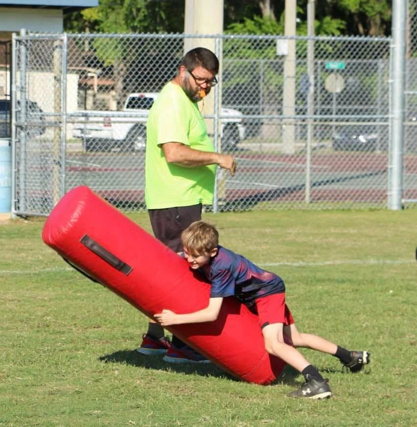Young player hitting a tackling dummy at practice
