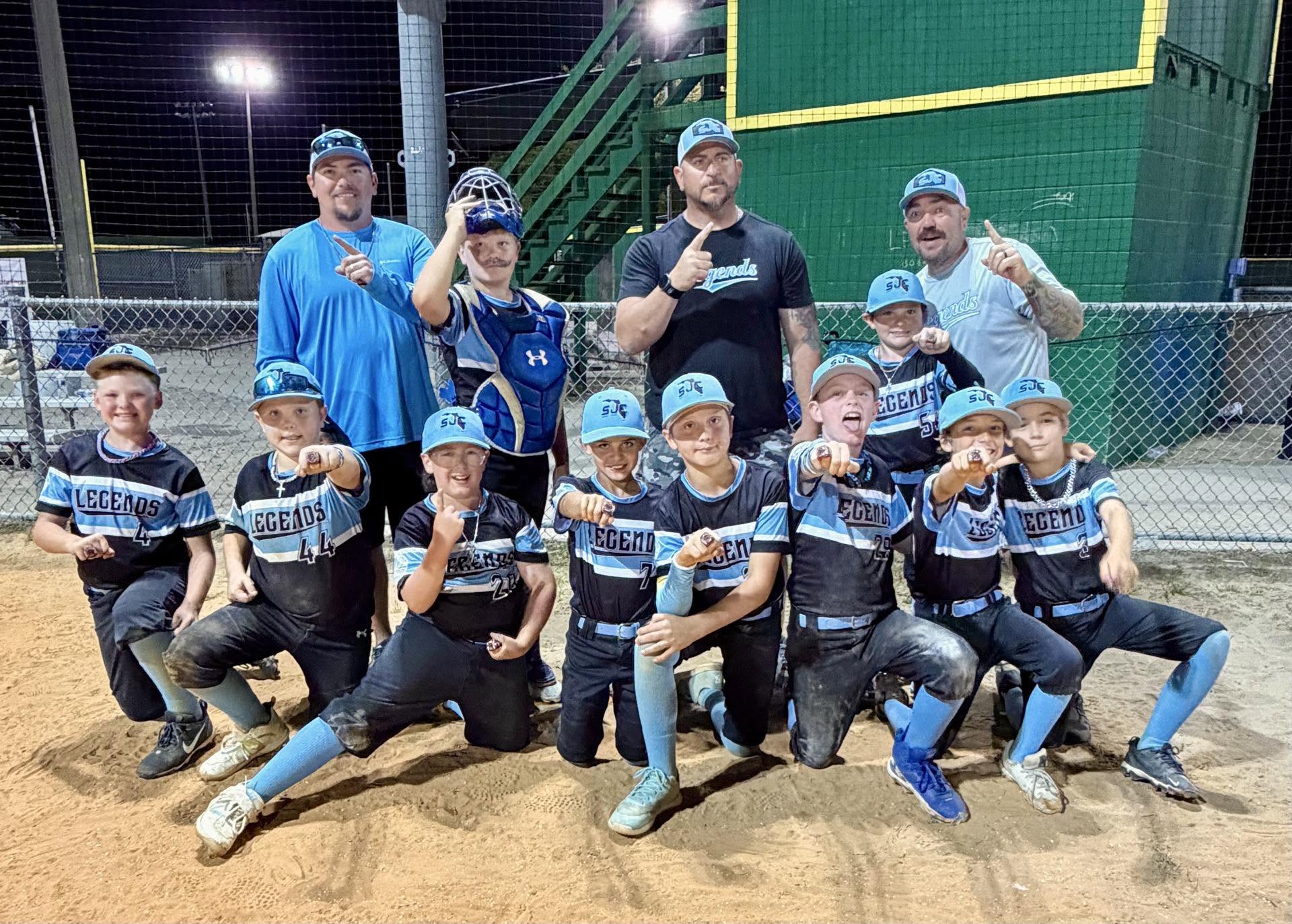 SJC Legends 11U players showing off championship rings at night